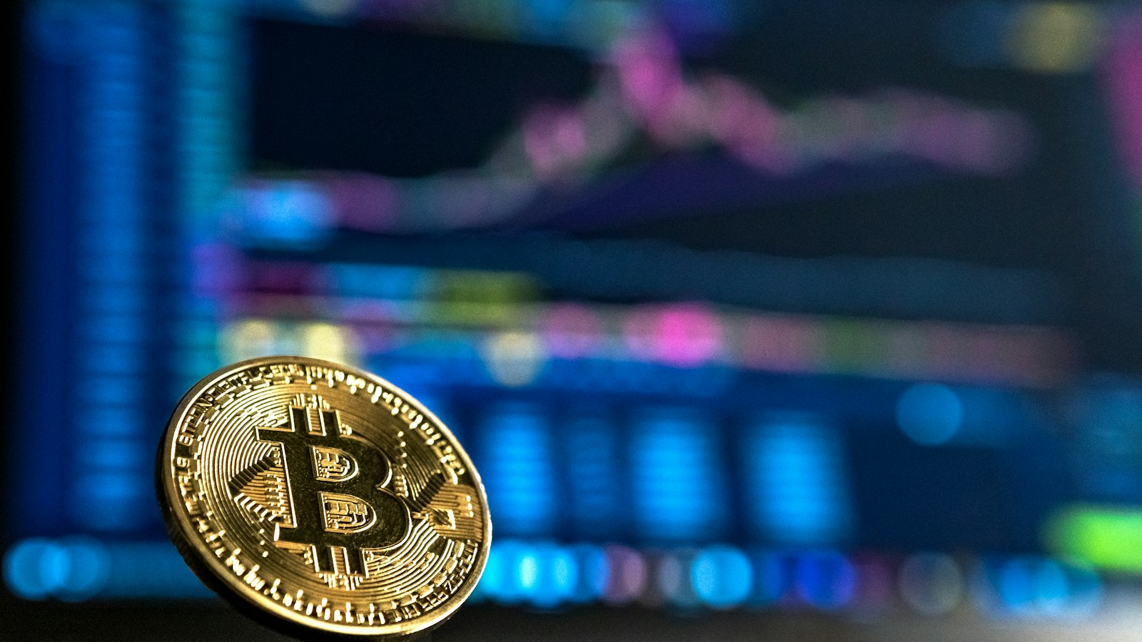 Gold physical Bitcoin coin standing upright in sharp focus