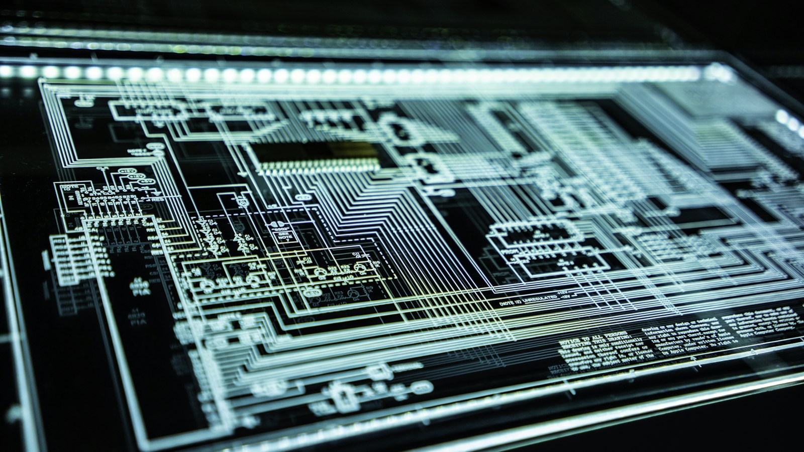 Illuminated circuit schematic on a dark technical display