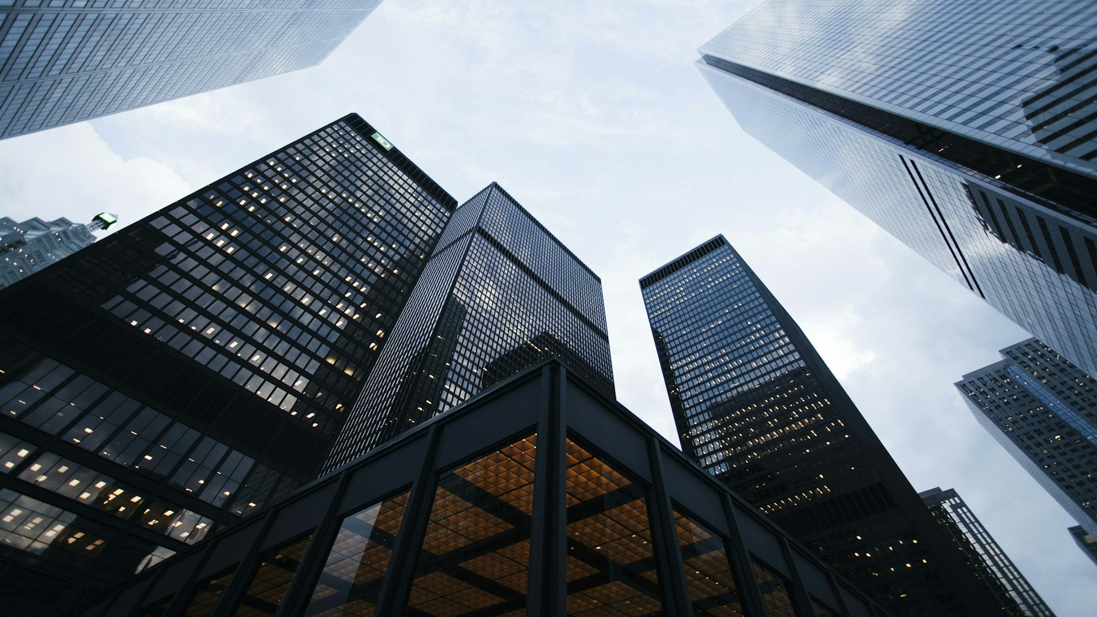 Looking up at modern glass skyscrapers in a financial district