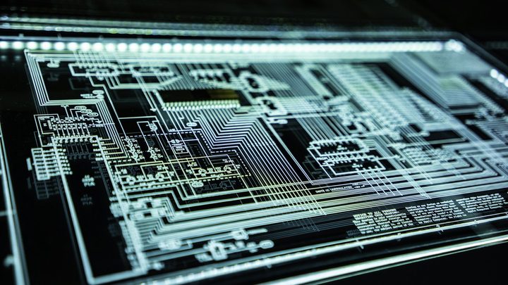 Illuminated circuit schematic on a dark technical display