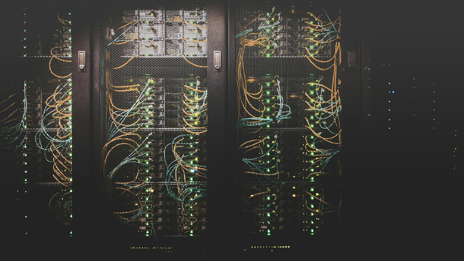 Server racks with glowing status lights and network cabling in a data center